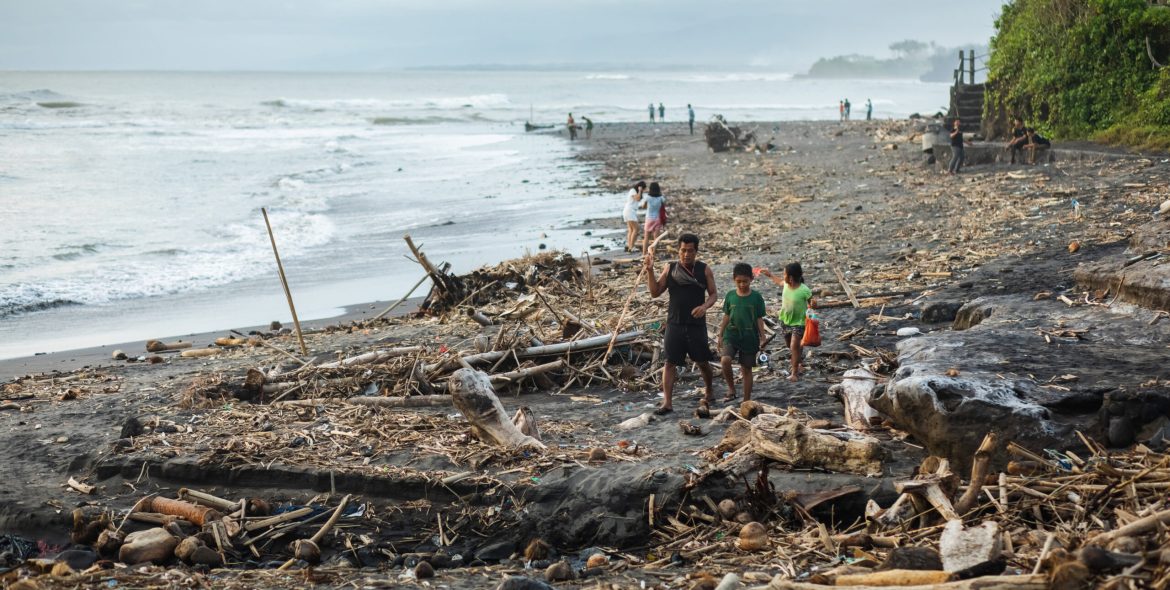 BALI, INDONESIA - APRIL 31, 2019: Beach pollution in Bali. Hard life of local people around garbage on the beach. Recycling waste problem
